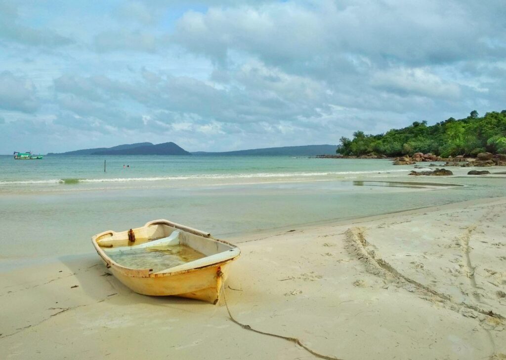 Secluded beach on Koh Rong Island with palm trees and calm sea