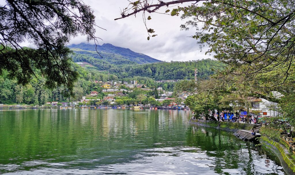 Telaga Sarangan lake surrounded by green mountains in East Java, Indonesia